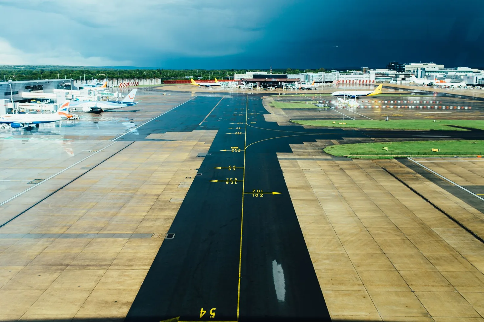 Passenger checking flight delay compensation rules at an airport departures board