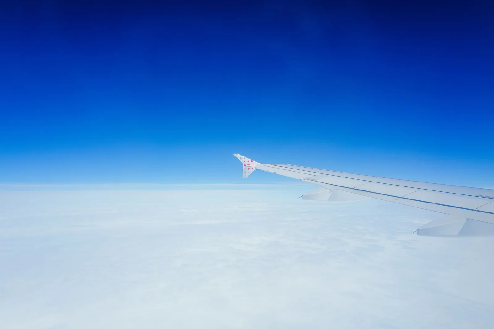 Passenger sleeping on an overnight flight in a dim cabin
